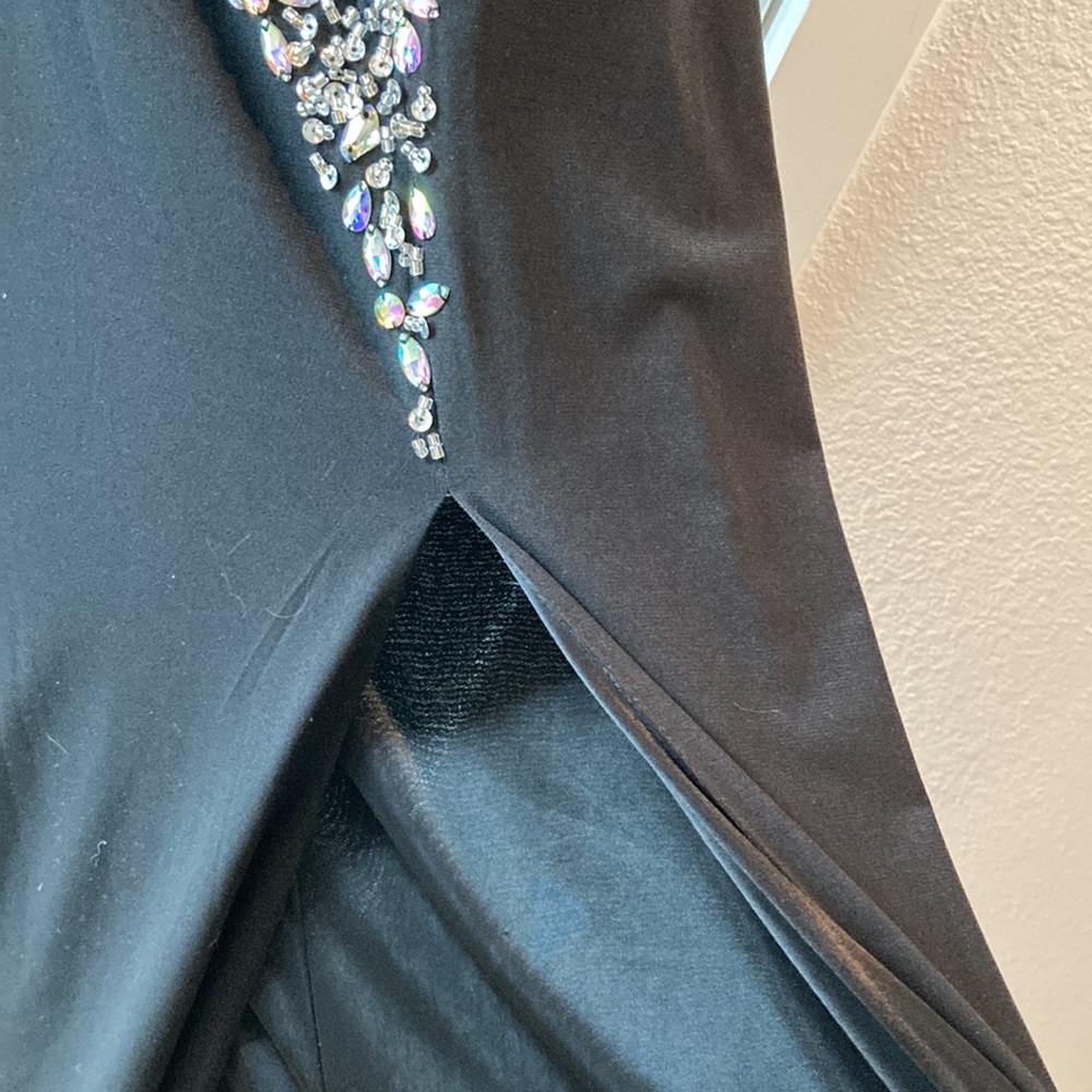 Long bejeweled black prom dress with thin straps and slit up to the thigh. - Picture 9 of 12